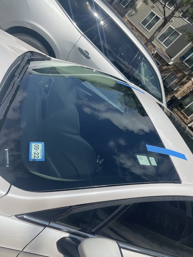 Newly installed windshield curing with retention tape